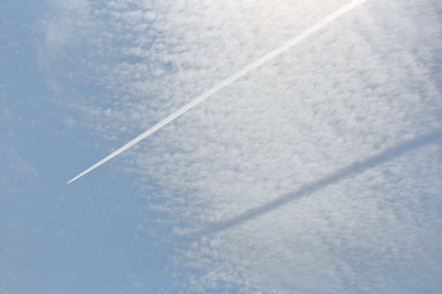 宮崎空港上空を通過する飛行機雲の影がその下の雲に映し出された